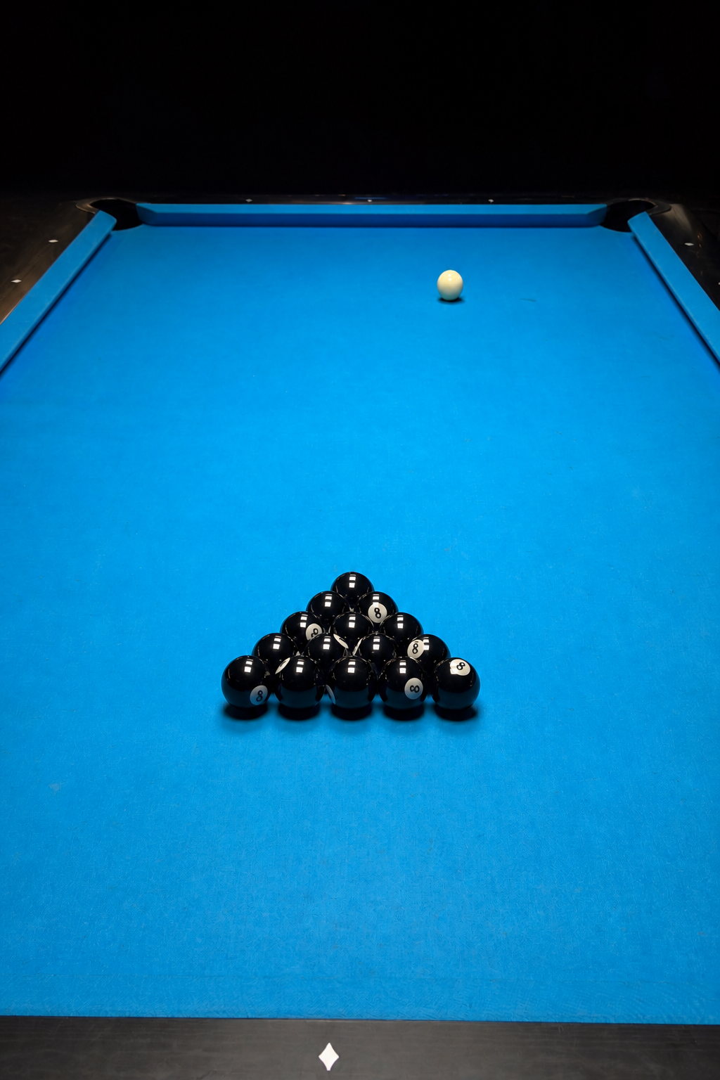 Overhead view down a blue pool table: a triangle rack of fifteen identical black 8-balls and a cream cue ball farther up-table